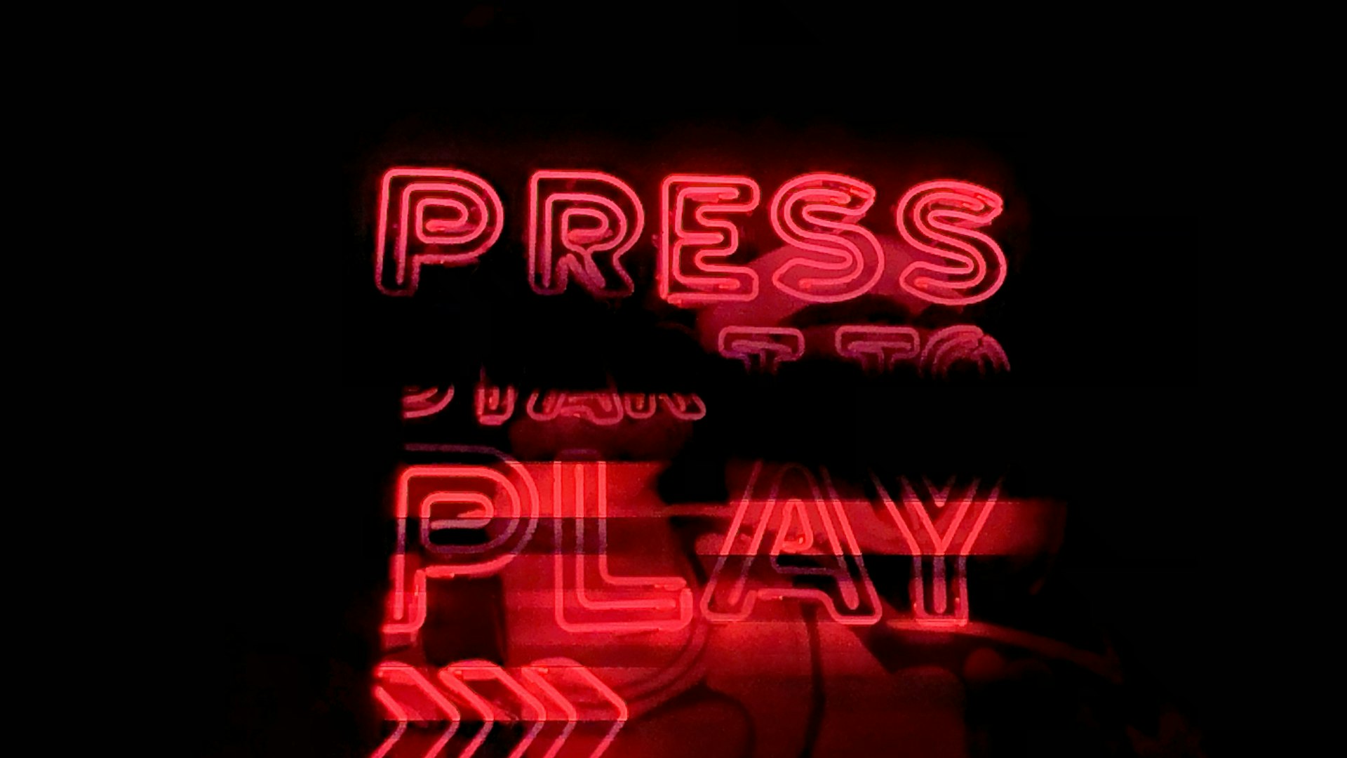 Neon-lit retro gaming lounge with rows of battlestations